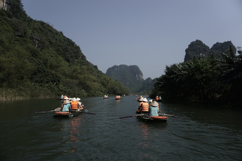 a group of people in small boats on a river