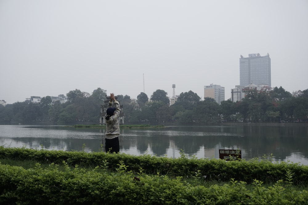 a person standing in front of a body of water