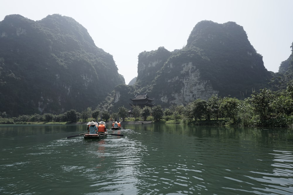 a couple of people in a small boat on a river