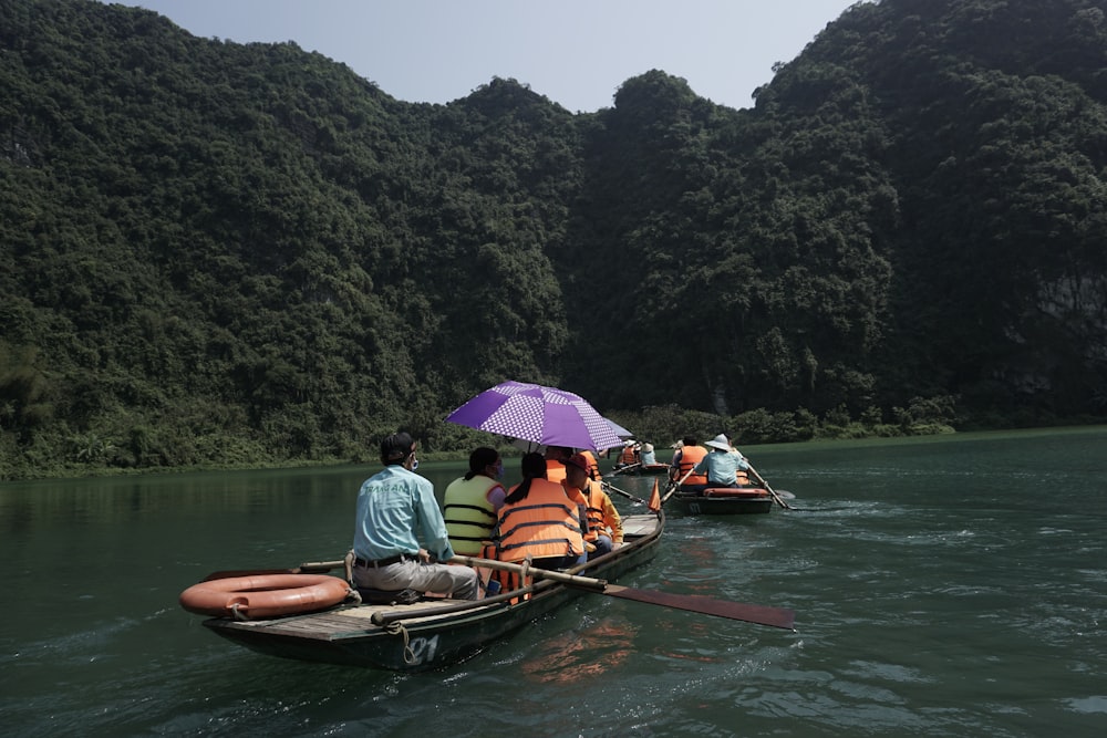 a group of people riding on the back of a boat