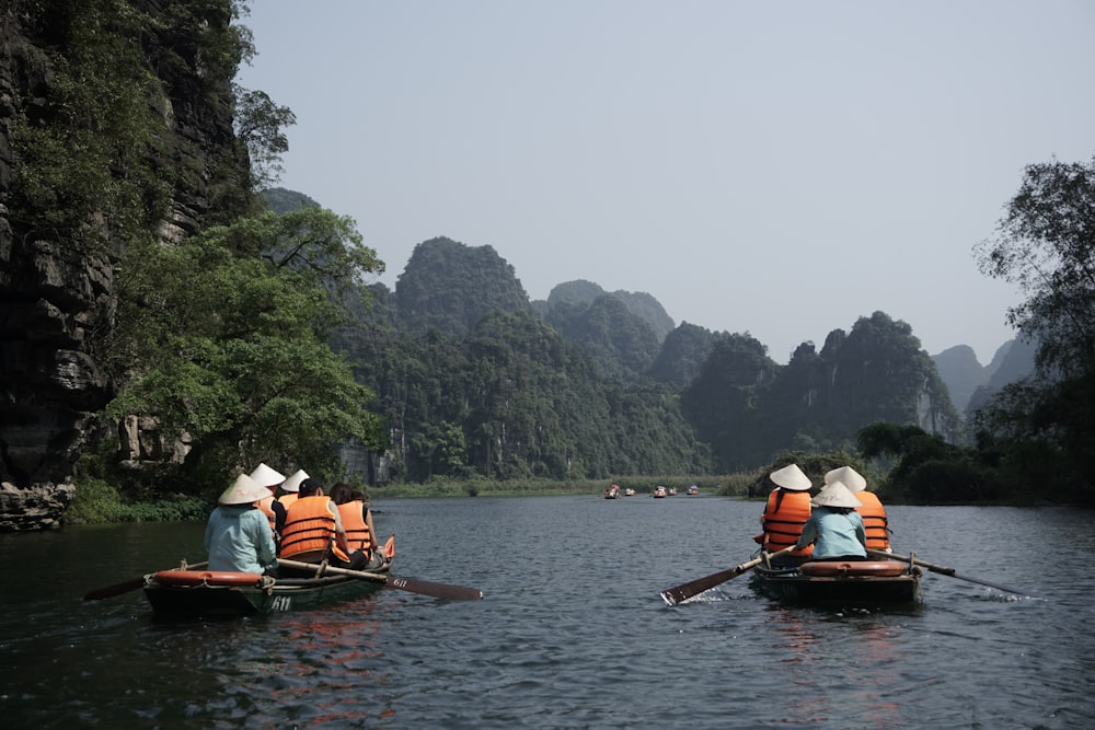 a couple of people on small boats in the water