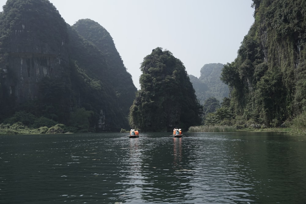 a group of people in small boats on a river