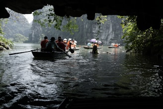 a group of people in a boat on a river