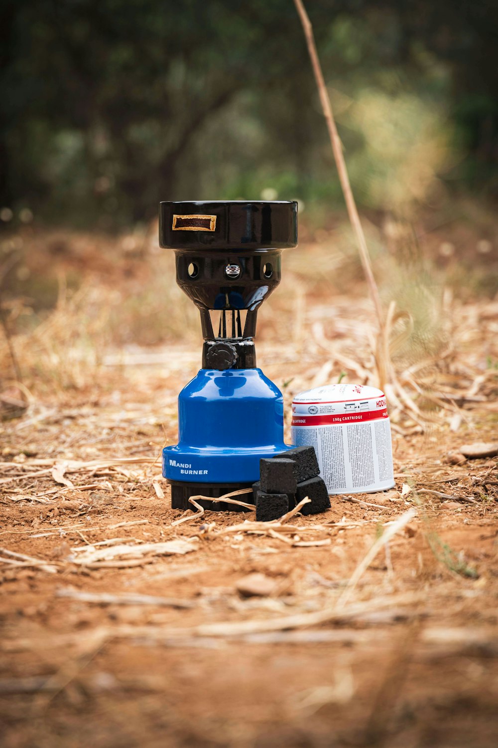 a couple of cans sitting on top of a dirt field