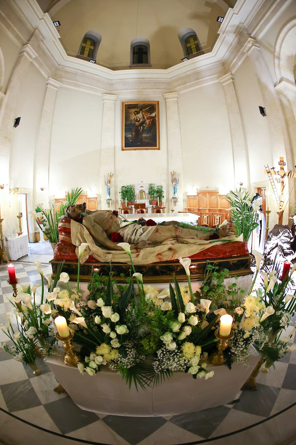 a room with a bed and flowers on the floor