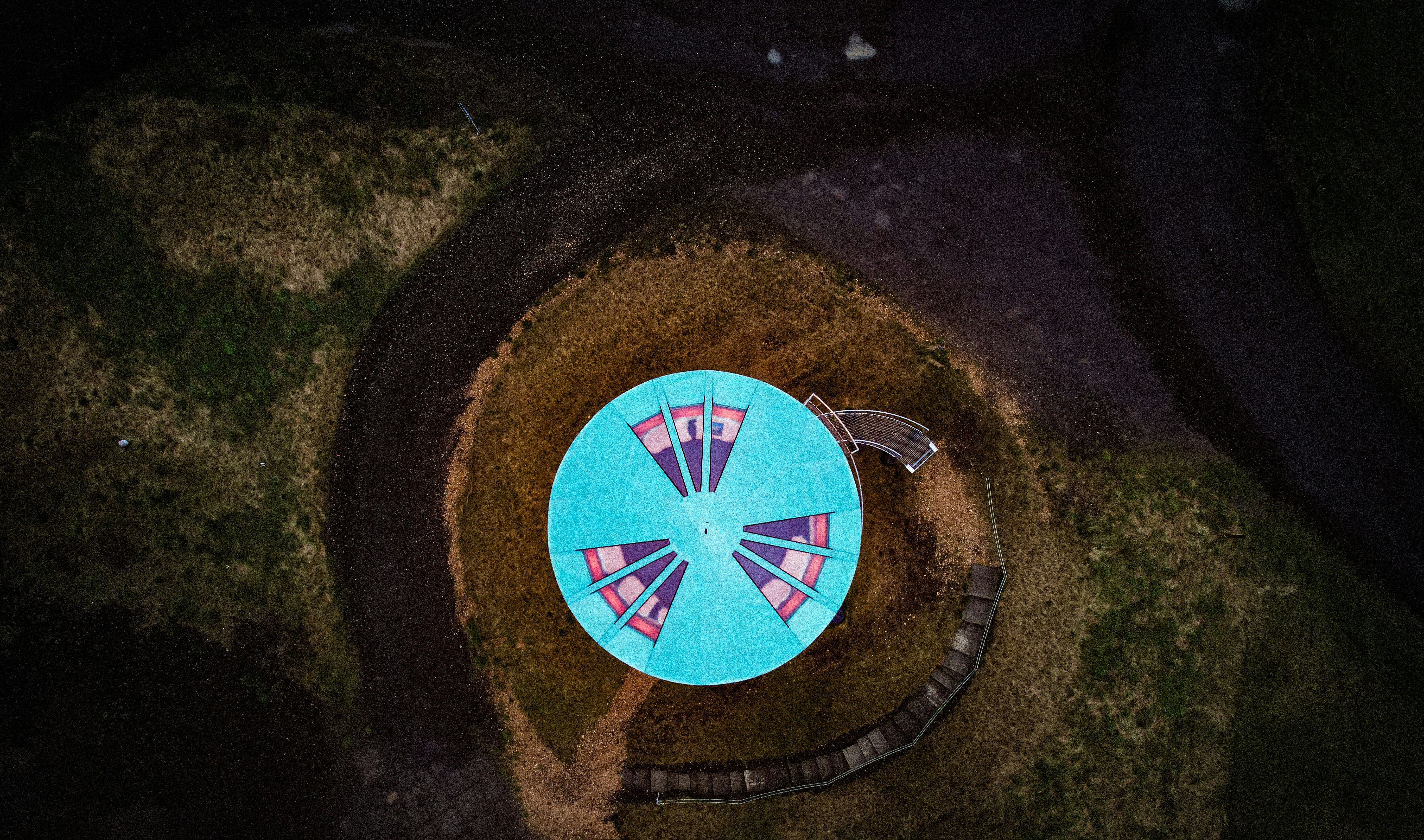 An aerial view of a blue table with flags on it