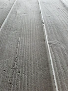 Close-up of groove cutting detail on concrete surface with precision tools.