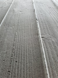 A close-up of a smooth concrete floor with a subtle texture.