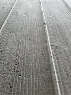 Close-up of smooth, freshly poured concrete surface ready for finishing.