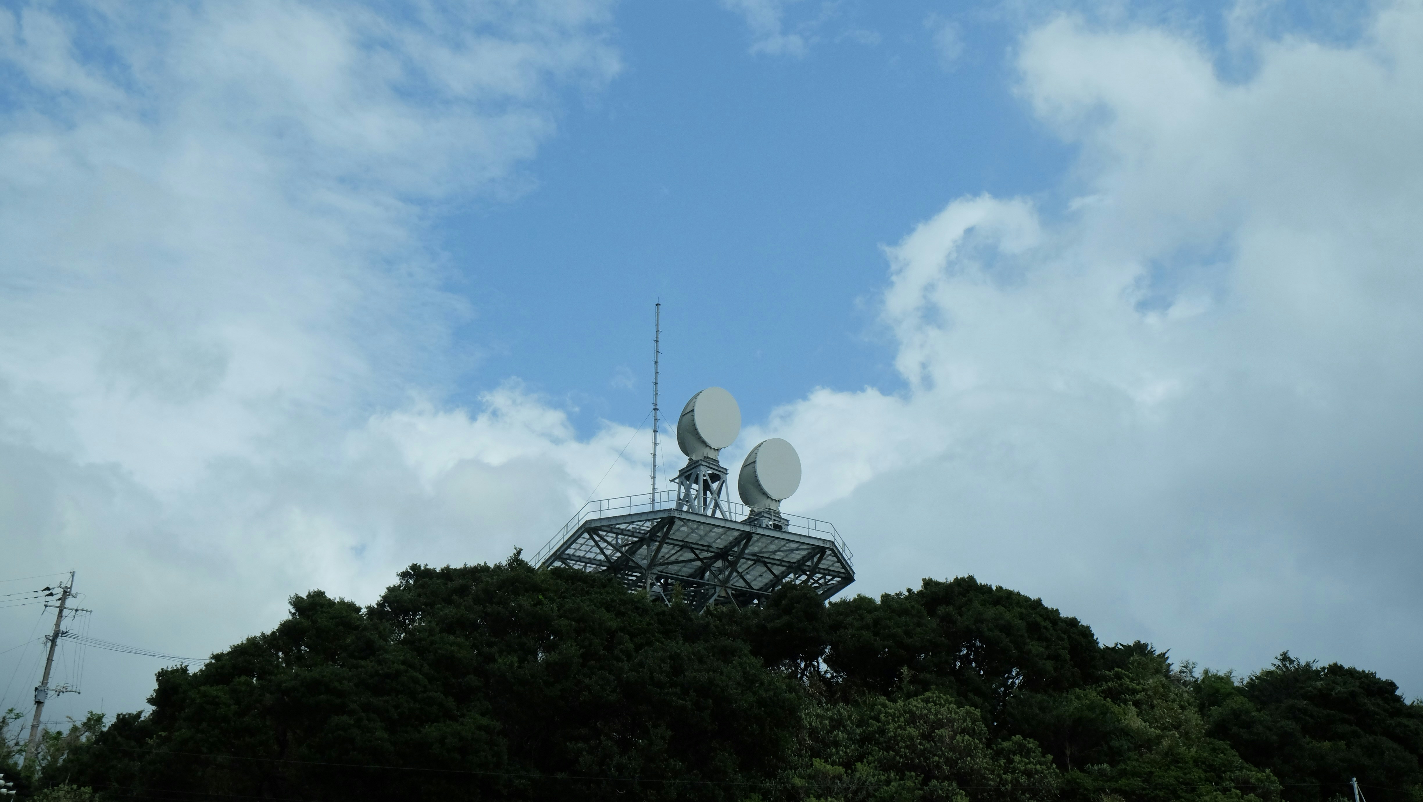 a satellite dish sitting on top of a hill