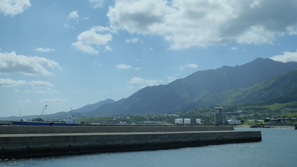 a large body of water with mountains in the background