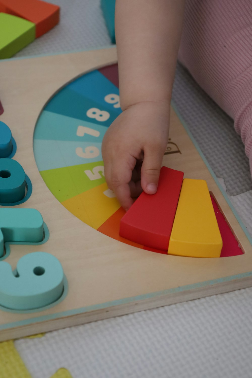 a young child playing with a wooden toy