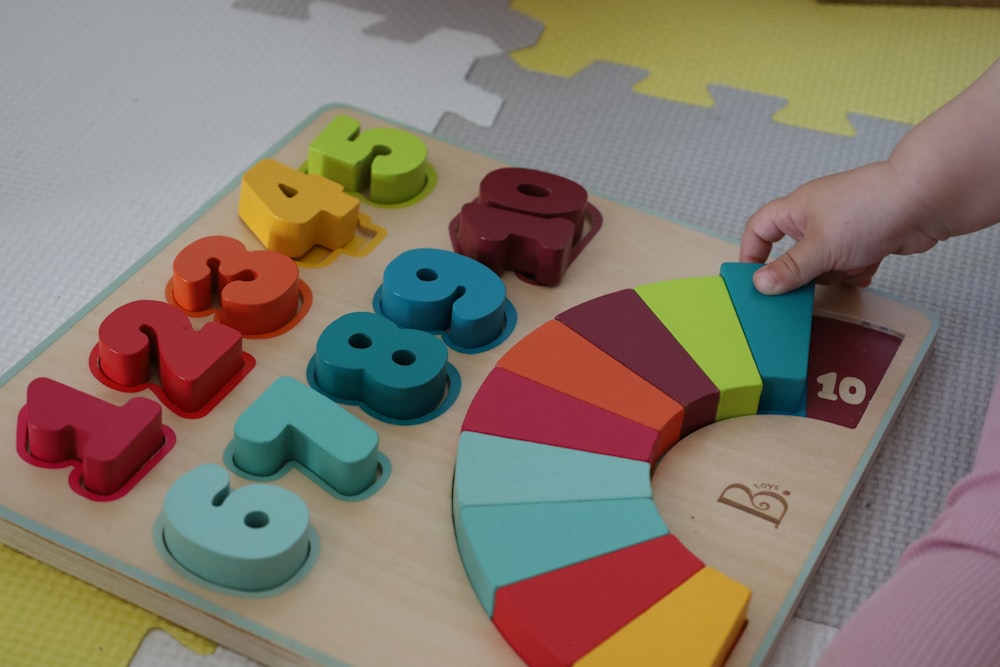 a child is playing with a wooden toy