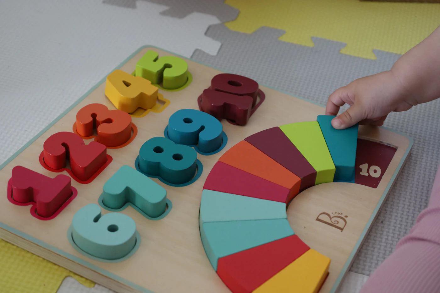 Child exploring colorful wooden learning pieces during independent play