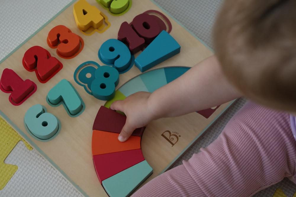 a child is playing with a wooden toy