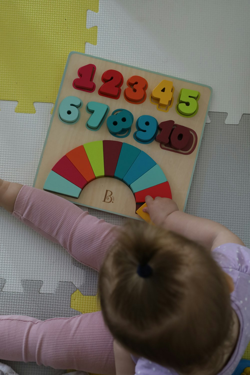 a little girl is playing with a toy