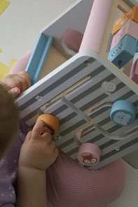 A speech therapist working one-on-one with a young child using picture cards.