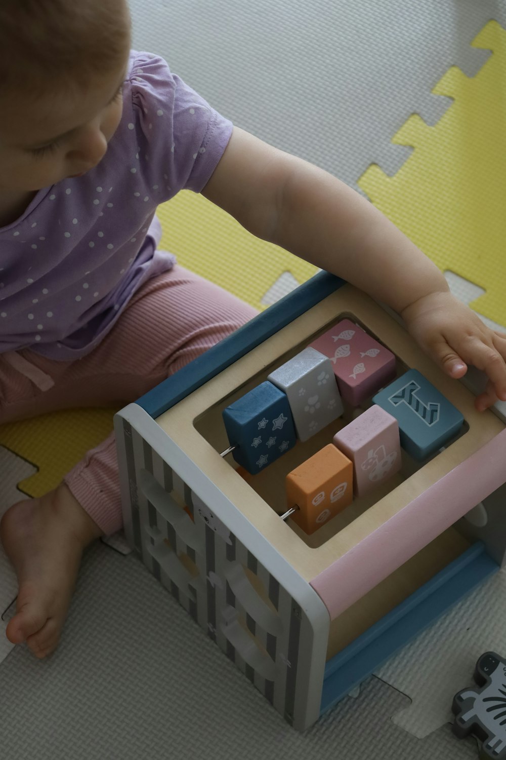 a toddler playing with a toy set on the floor