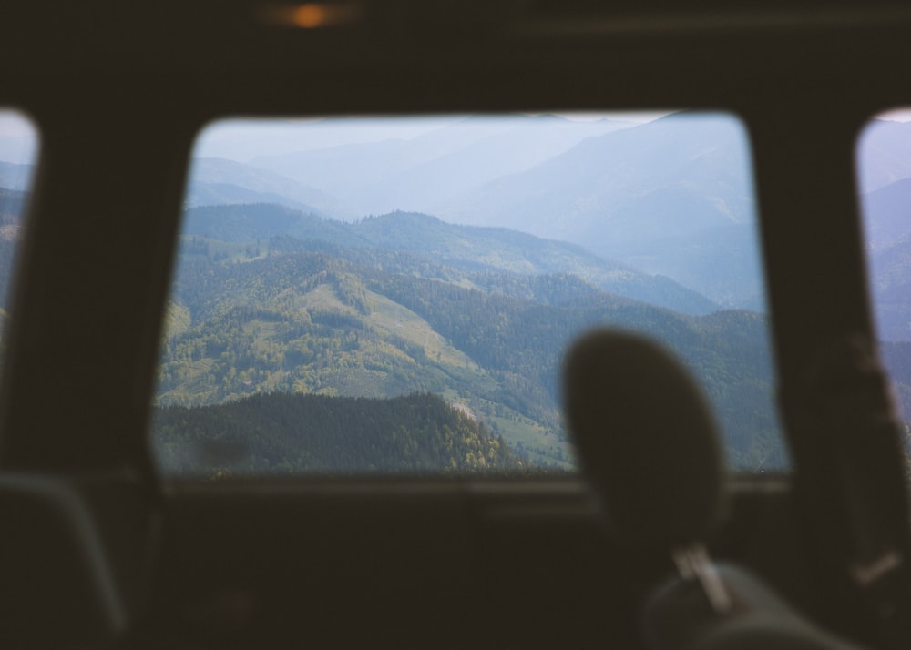a view of mountains from inside a vehicle