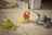 Three toy figures are positioned on a tiled floor, with a shoe partially visible in the background. The figures are styled as cartoon characters with vibrant colors and exaggerated features.