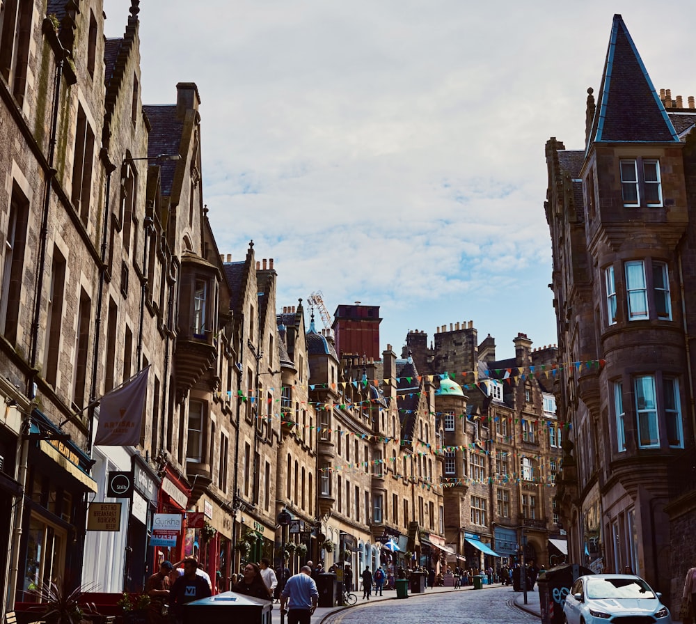 a city street lined with tall brown buildings