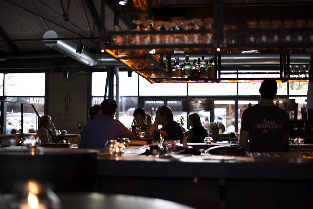 a group of people sitting at a table in a restaurant