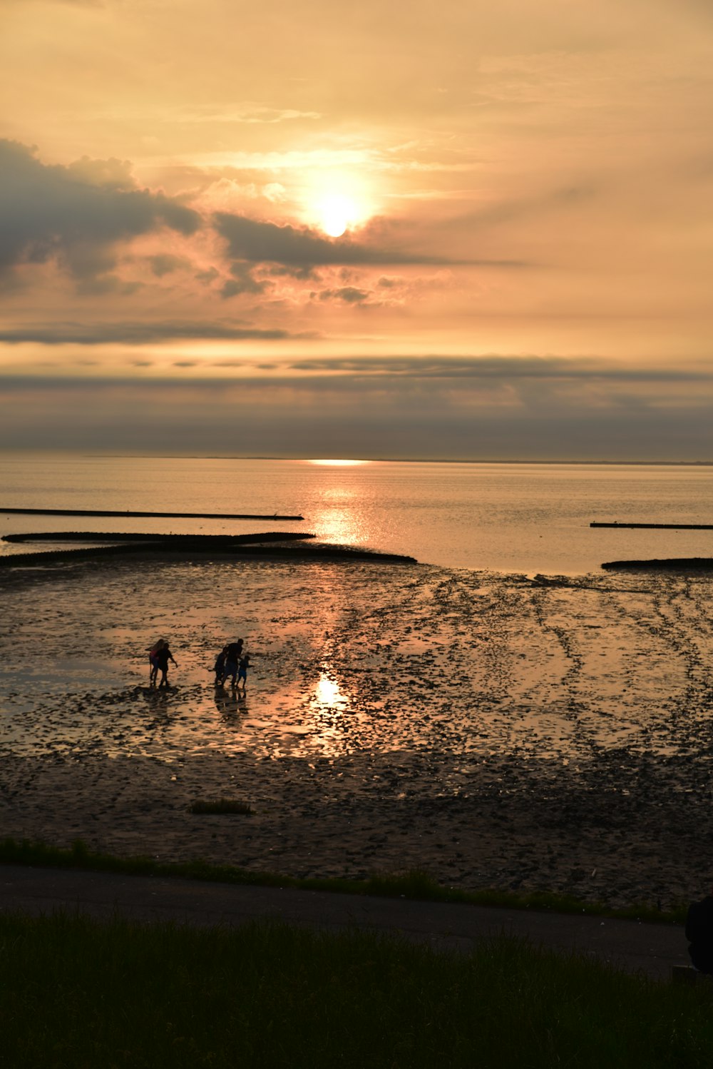 a couple of people standing on top of a beach