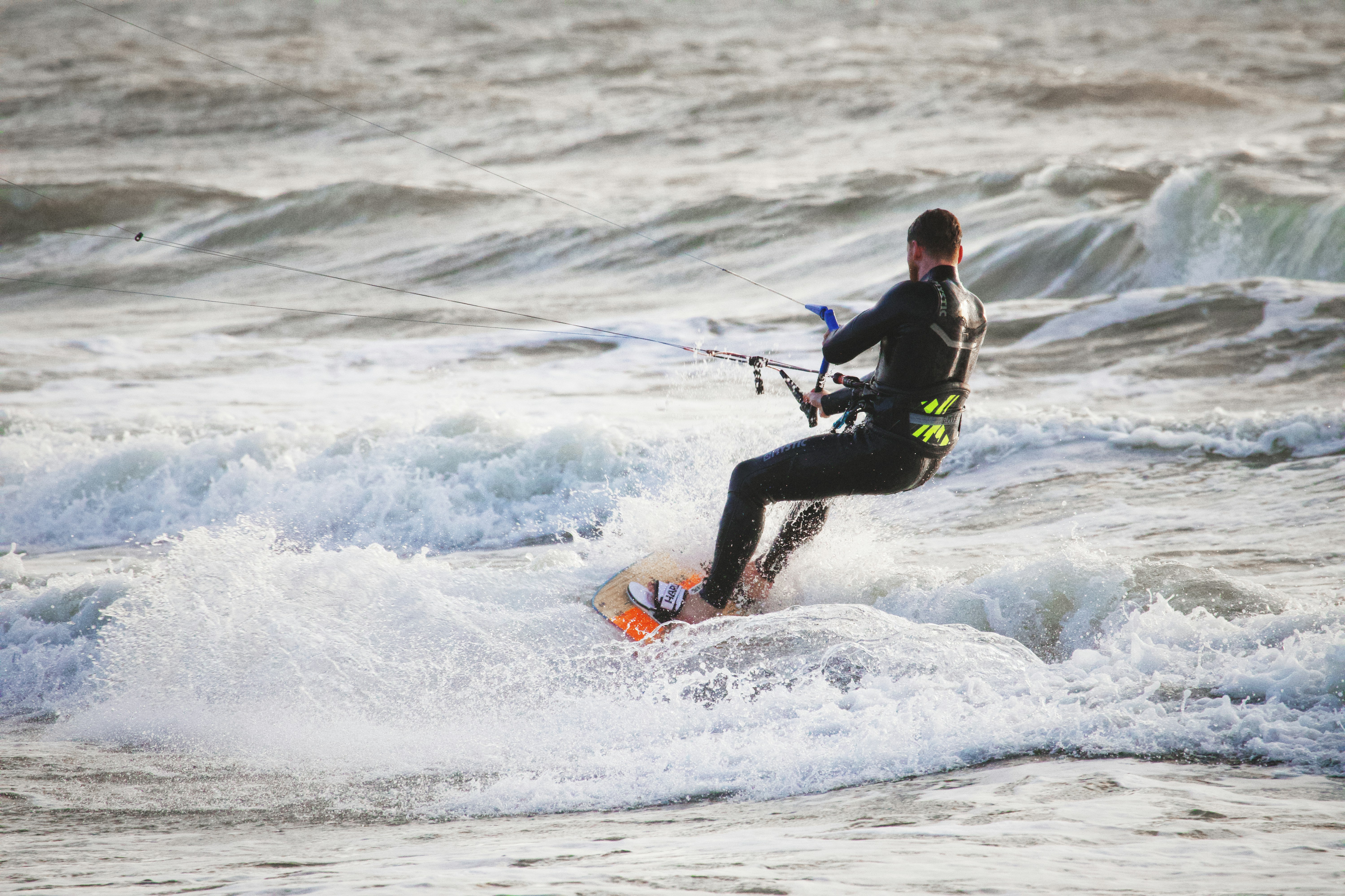 a man riding a wave on top of a surfboard