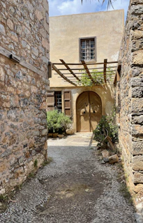 A sturdy stone walkway leading to a cozy cottage, showcasing expert tile and stone work.