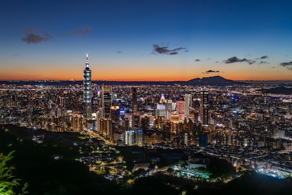 a view of a city at night from the top of a hill