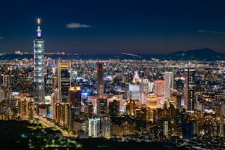 a view of a city at night from the top of a hill