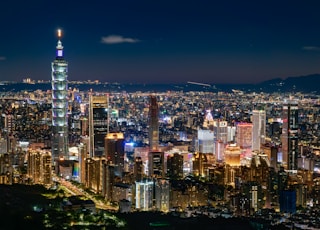 a view of a city at night from the top of a hill