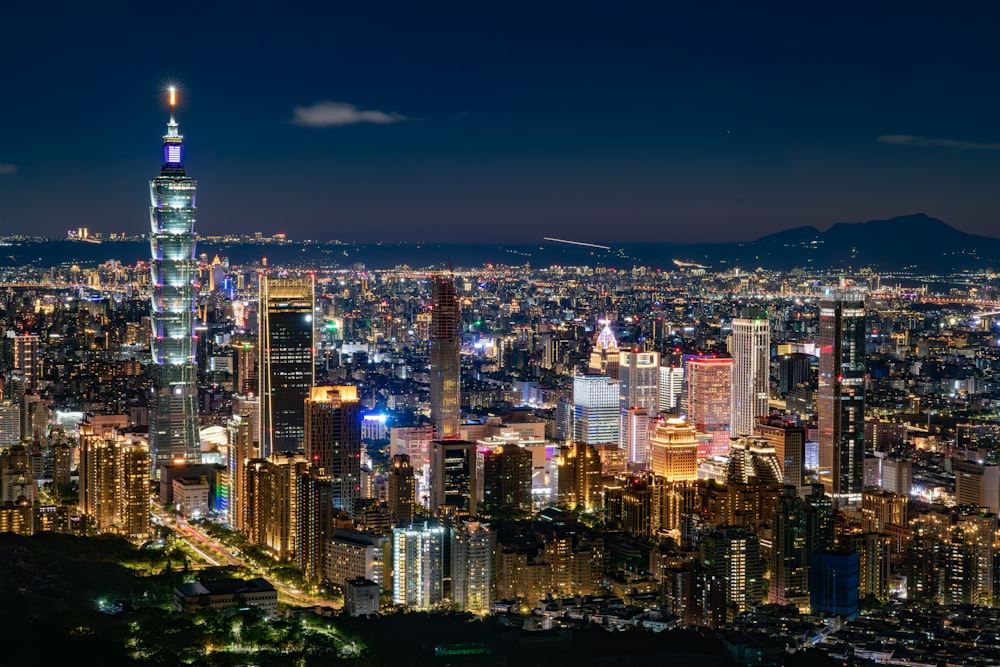 a view of a city at night from the top of a hill