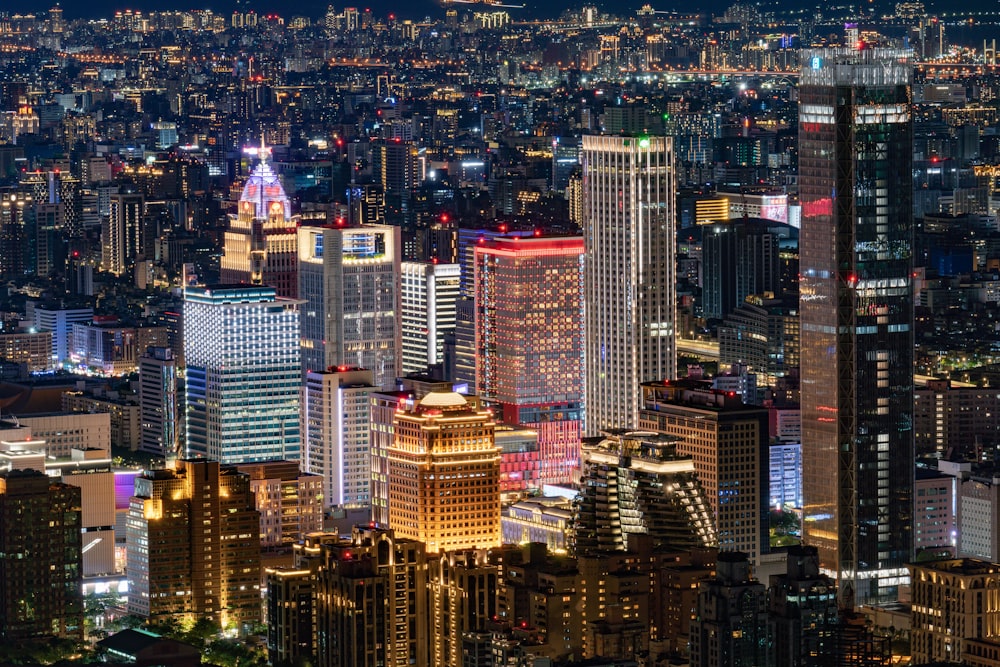 a view of a city at night from the top of a skyscraper