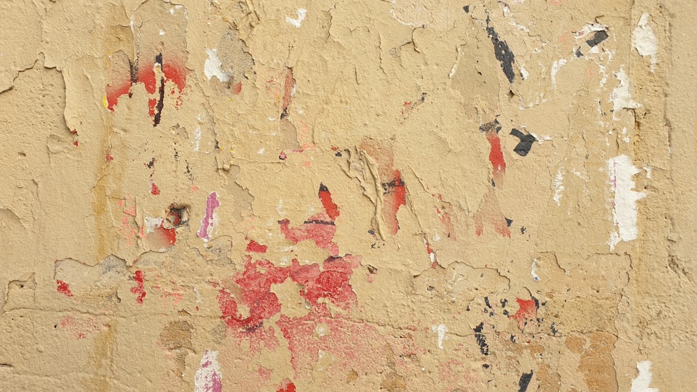 a close up of a wall with peeling paint