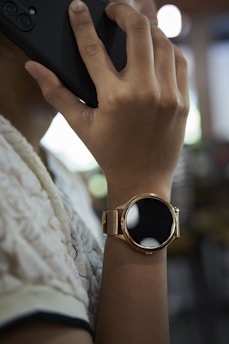 A close-up of a contractor's hand holding a smartphone displaying an incoming call from a homeowner.