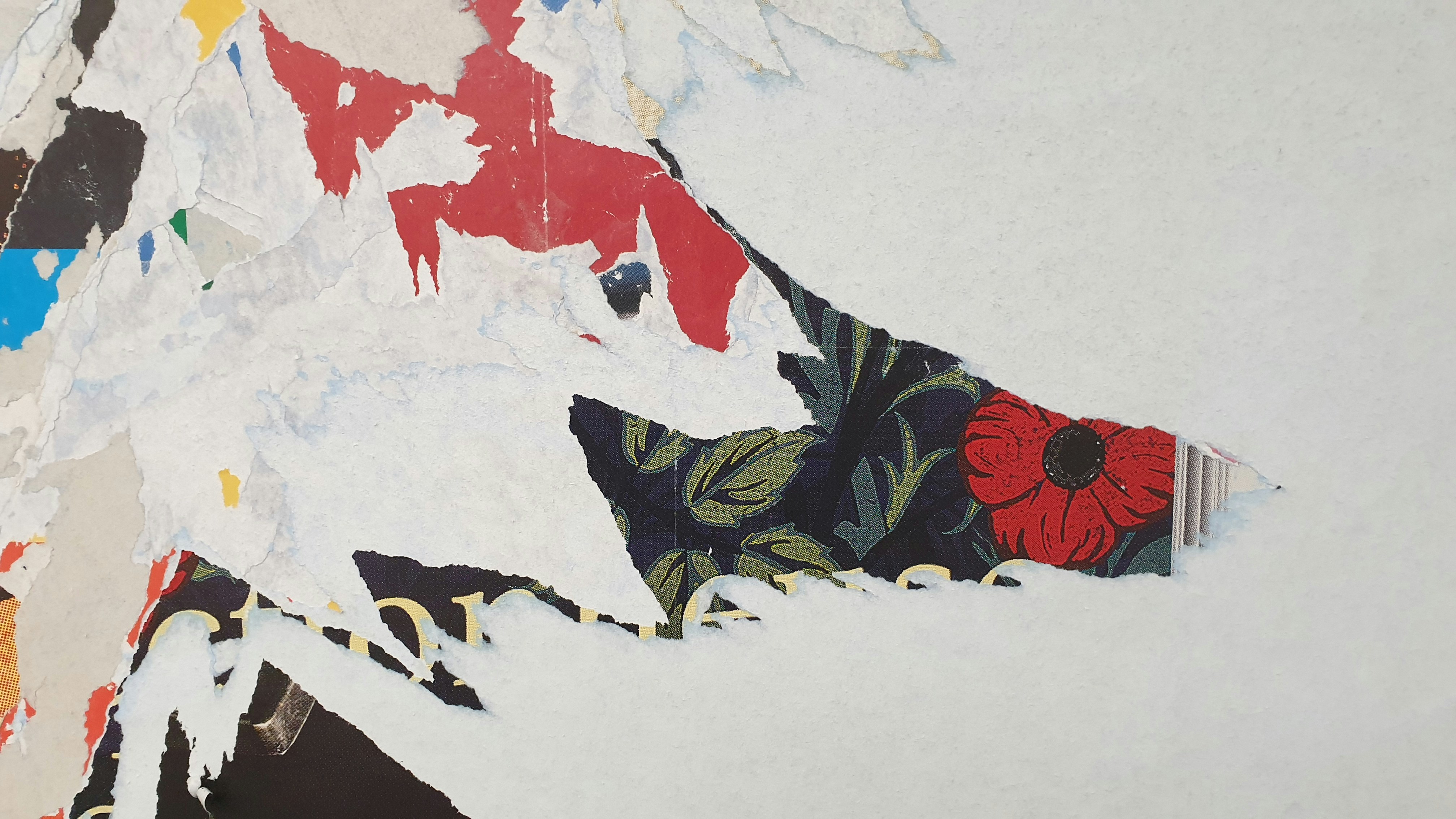 a torn piece of paper with a flower on it