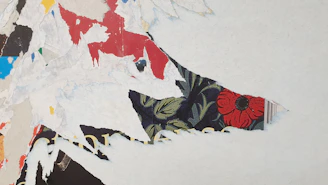 Close-up of a vibrant mixed-media collage showcasing layered textures and bold colors.