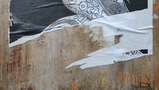 A close-up of a vintage poster framed with elegant wooden edges, highlighting the texture and colors.