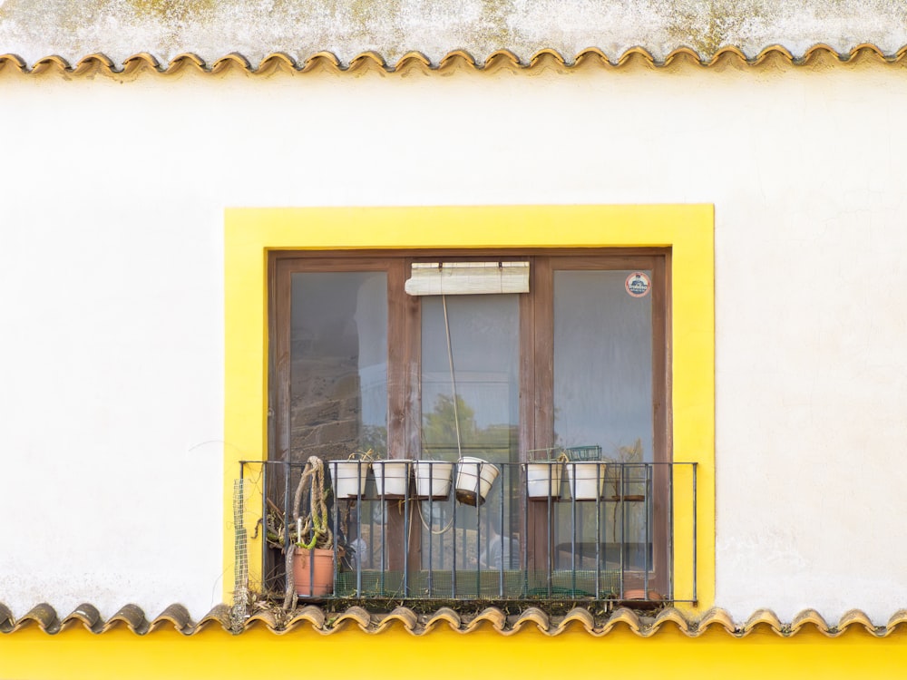 a balcony with a potted plant on the window sill