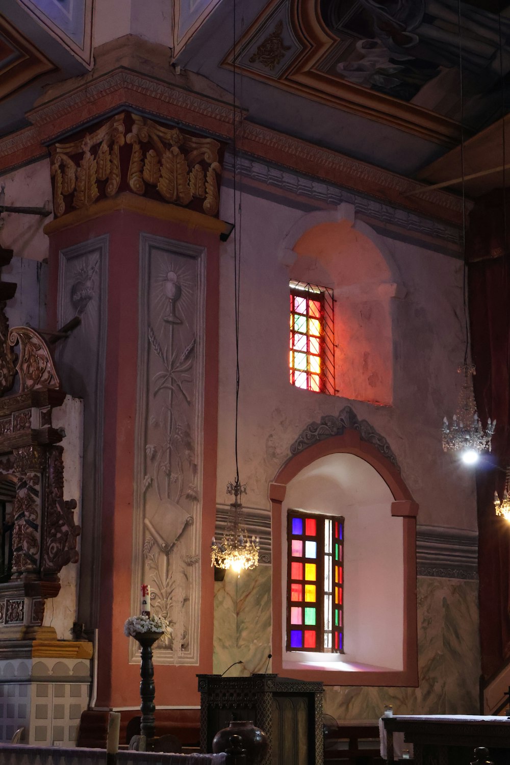 a church with stained glass windows and a chandelier