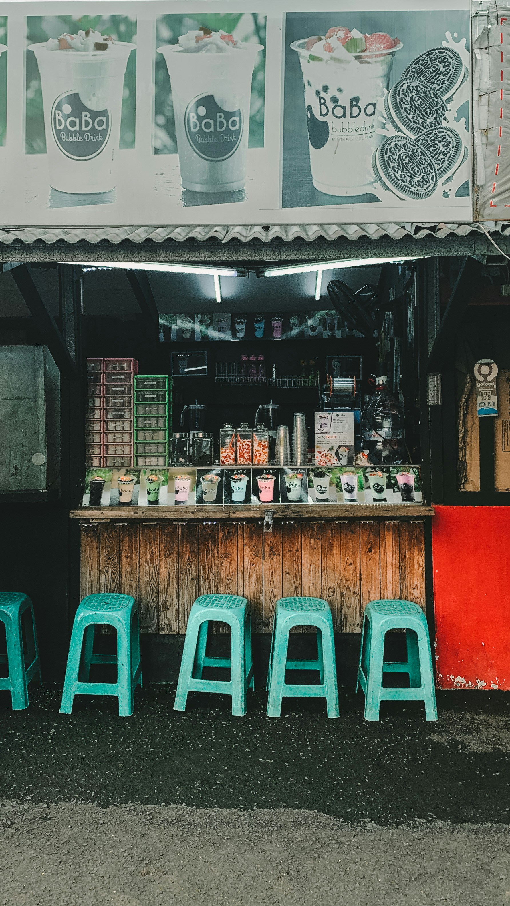 Row of specialty bubble tea drinks with various flavors and toppings, bright airy café interior