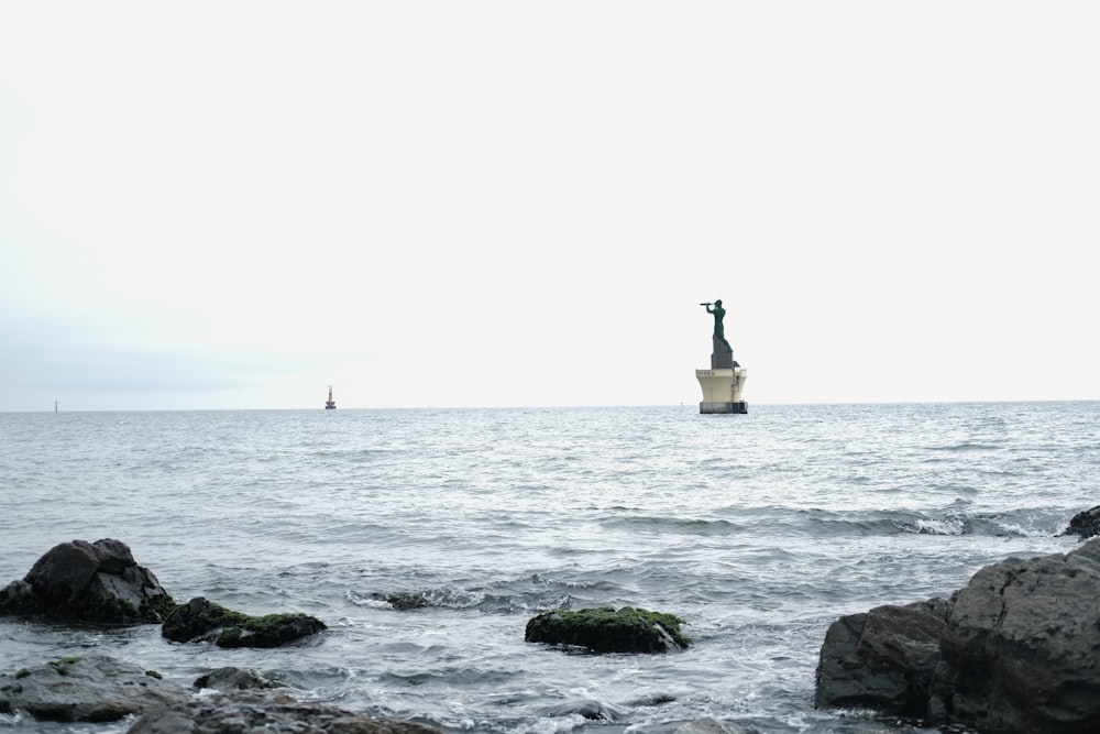 a boat is in the water near some rocks