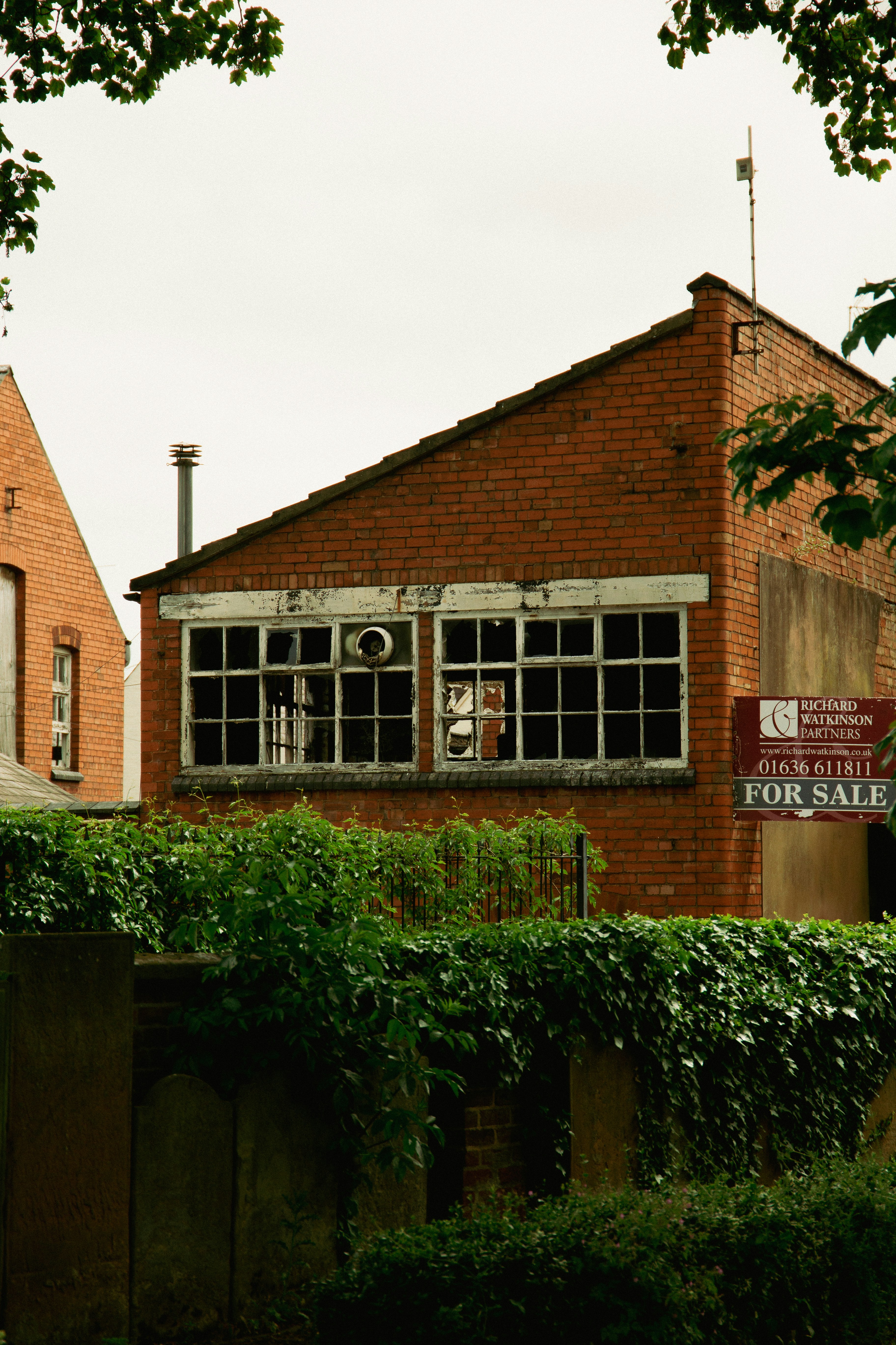 a brick building with a clock on the front of it