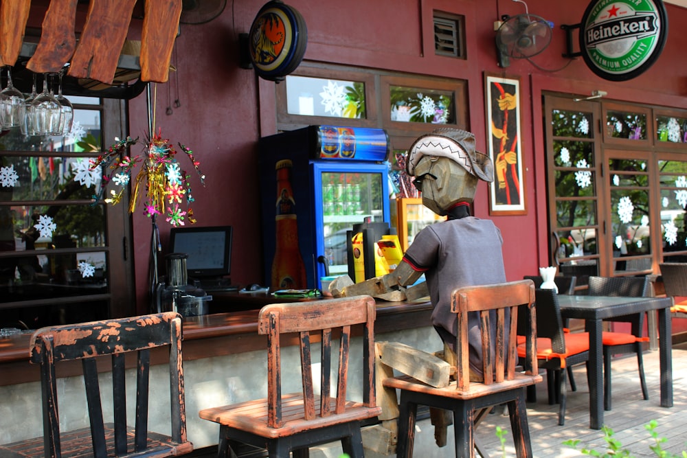 a person sitting at a counter in front of a restaurant