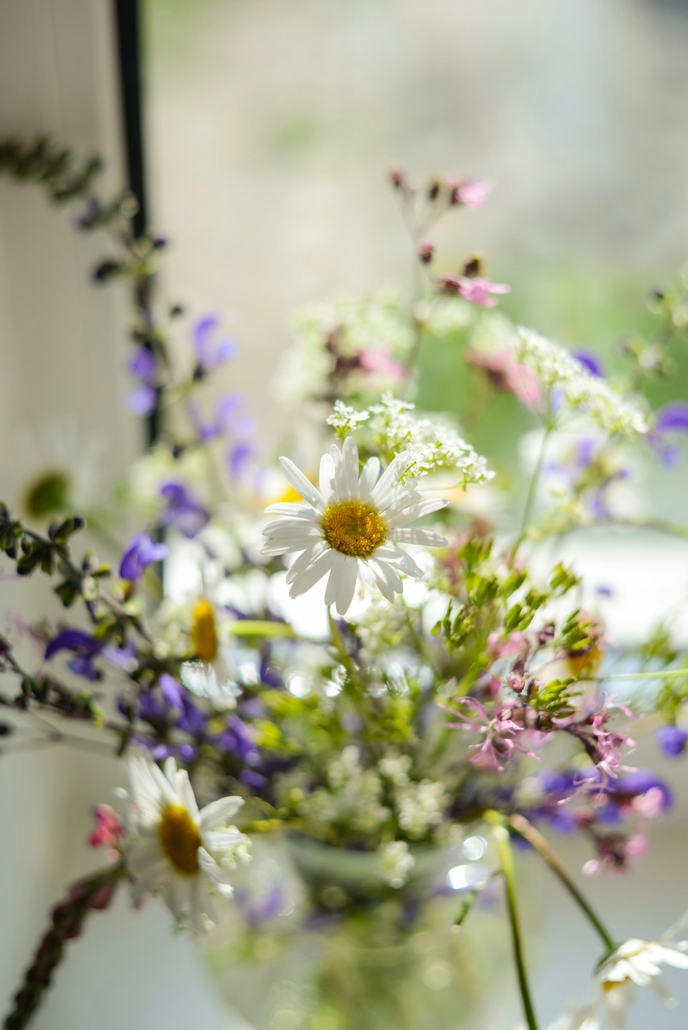 a vase filled with lots of different types of flowers