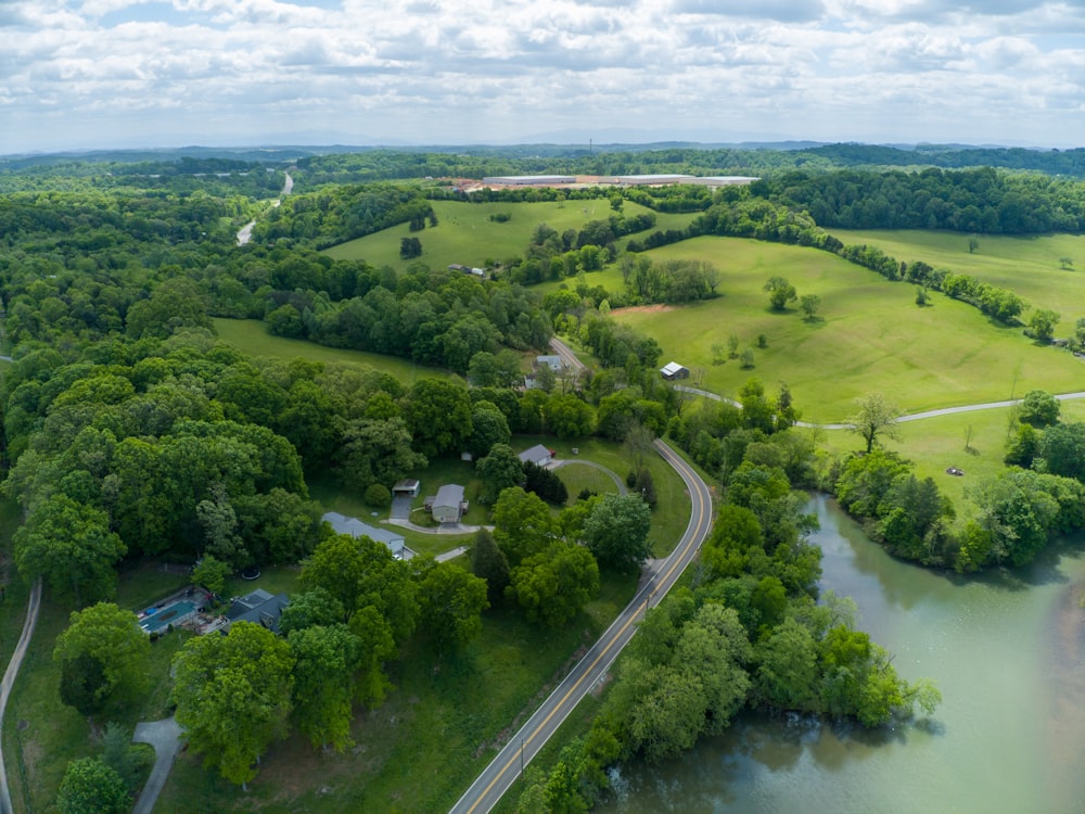 an aerial view of a river running through a lush green countryside