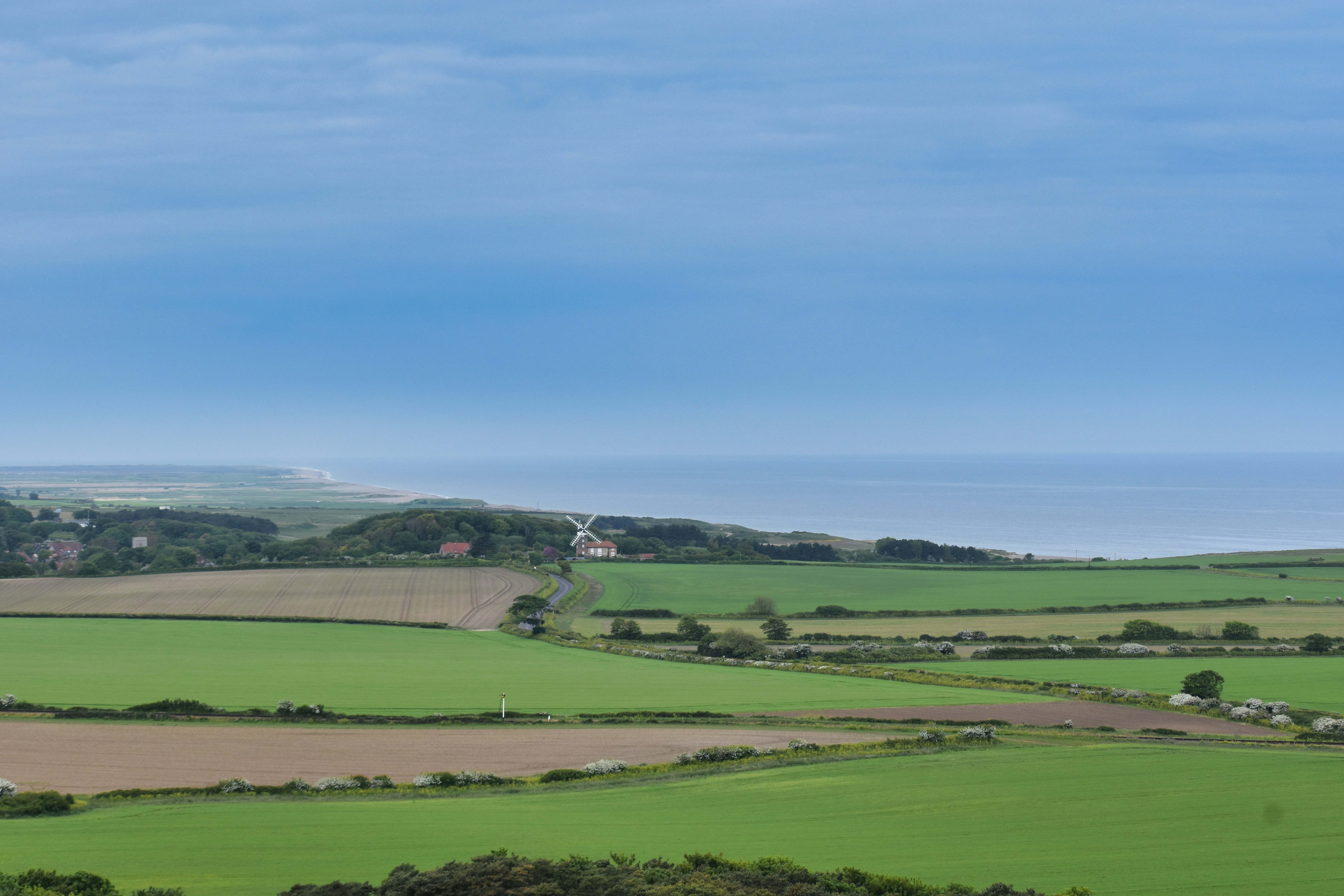 a view of the countryside from a hill, 
