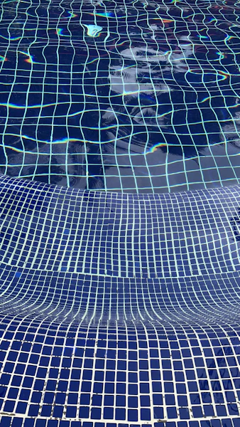 a blue tiled swimming pool with blue tiles