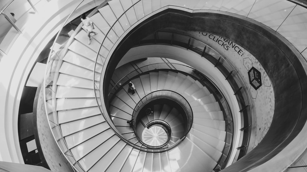 a black and white photo of a spiral staircase